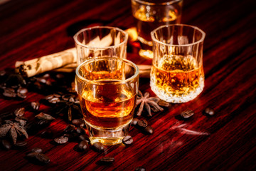 Brandy or liquor,Set of strong alcoholic drinks in glasses and shot glass on dark wood background