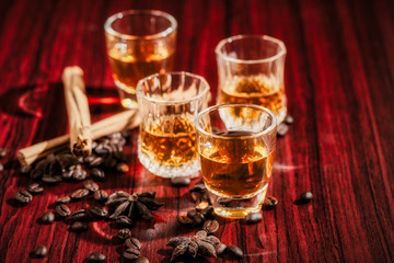 Brandy or liquor,Set of strong alcoholic drinks in glasses and shot glass on dark wood background