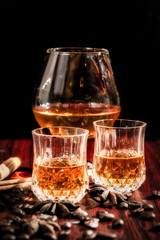 Brandy or liquor,Set of strong alcoholic drinks in glasses and shot glass on dark wood background