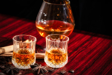 Brandy or liquor,Set of strong alcoholic drinks in glasses and shot glass on dark wood background
