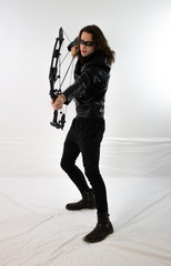 Mysterious man in black leather with compound bow