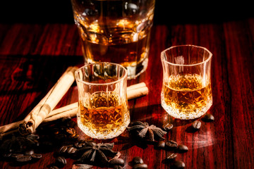 Brandy or liquor,Set of strong alcoholic drinks in glasses and shot glass on dark wood background