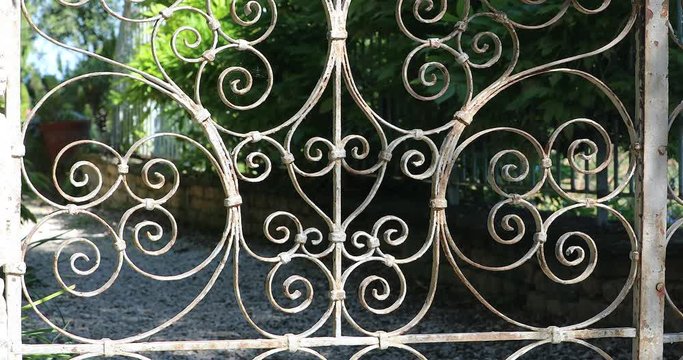 Ornate Wrought Iron Gate With A Beautiful Park In The Background. Close Up View - DCi 4K Video