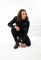 Man in black leather crouching