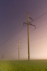 electric pole at night in the fog