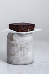 Vegan raw brownies with nuts and dates, on white marble background with copy space. Healthy dessert concept