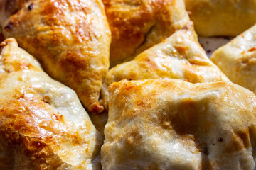 Bowl with delicious samosas on light background