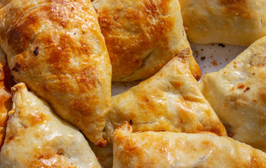 Bowl with delicious samosas on light background