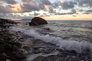 Sunset on a wild beach on sea