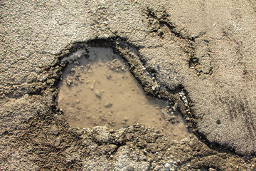 there are many potholes on the roadway close up