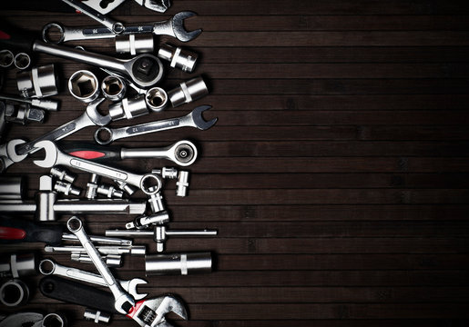 many spanners on a wooden black background