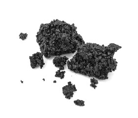 Piece of fresh asphalt isolated on white background. Pile of black raw asphalt.