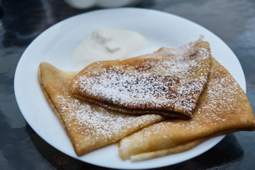Pancakes in powdered sugar on plates