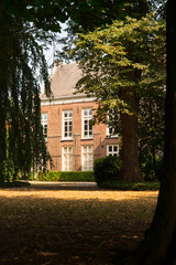 building and trees in shadow,  public park Stadhuistuin, Tiel, The Netherlands