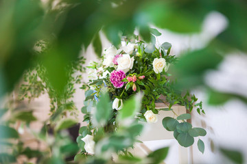 Blurred front background of leaves, beautiful flowers in the background.