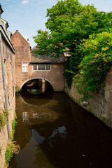 Fototapeta na wymiar canal with brick wall, reflection in Den Bosch, 's Hertogenbosch, The Netherlands