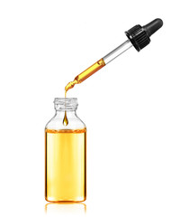 Drop drops from a pipette in a cosmetic bottle, isolated on white background