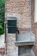 vintage sink stone outside building, in park, Tiel, The Netherlands