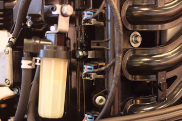 Fuel system of boat outboard motor close up, gasoline filter, injector wires, intake manifold and pump pipes