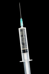 Closeup photo of syringe with money dollars inside isolated on black background