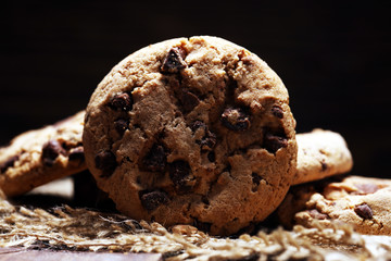 Fototapeta premium Chocolate cookies on wooden table. Chocolate chip cookies shot very delicious