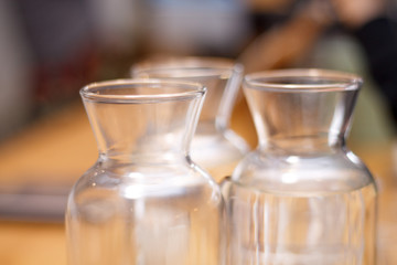transparent bottles close-up on yellow background
