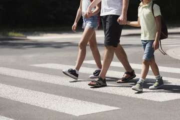 Deurstickers Father holding hands with his kids while on pedestrian crossing © Photographee.eu