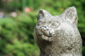 Fototapeta na wymiar Cat statue from stone. Lucky rock cat head