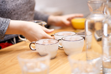 coffee and hands close-up in a coffee shop on a wooden table