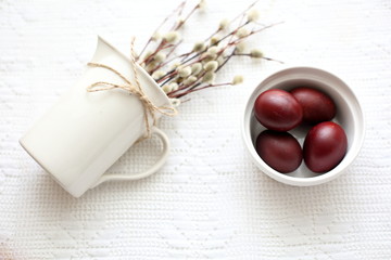 Easter still life with egg and willow on white background