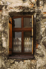 an old window with open shutters in an old house