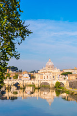Fototapeta na wymiar Saint Peter Basilica (San Pietro) in Vatican city with Saint Angelo Bridge over Tiber river