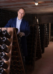 Wine producer controlling wine aging in winery vault