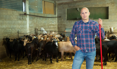 Male farmer holding agricultural tool