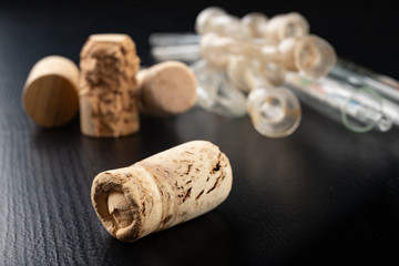 Fermentation tube and corkscrew on a black table. Accessories needed to prepare homemade wine.