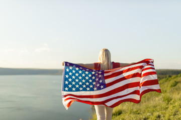 Young woman holding USA flag for freedom concept. American flag.