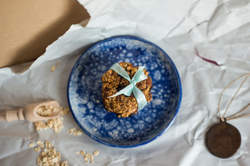 asty homemadeoats cookies decorated of blue satin ribbon on the creative bright blue plate