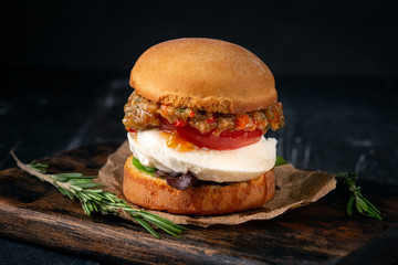 Vegetarian Burger made from fried eggplant, tomato, lettuce, avocado and mozzarella cheese on a...
