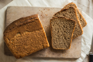 fresh homemade sourdough wheat form bread  served on the rustic background