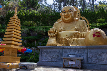 Panoramic view on the large golden praying sitting buddha. Korean Haedong Yonggungsa Temple. Busan, South Korea, Asian.