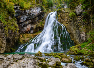 Fototapeta premium Gollinger Waterfall in Golling an der Salzach near Salzburg, Austria. Stunning view of cascade waterfall over mossy rocks in the Alps with long exposure