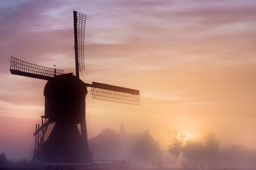 Obraz premium Old wooden windmil at sunrise