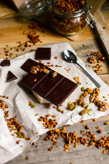 tasty dark chocolate with homemade granola on the rustic background wood table