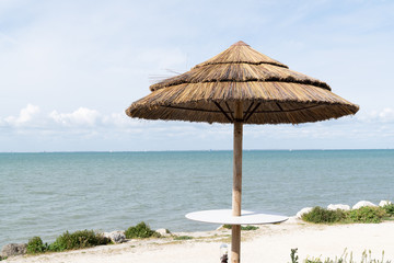 Straw umbrella on a beautiful tropical beach summer