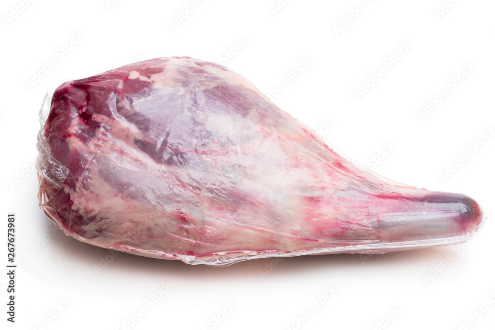 Wall mural Vacuum pack of raw lamb leg isolated on white