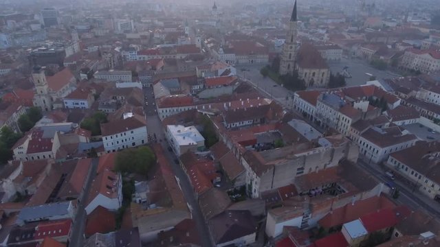 Close aerial drone shot of a city at sunrise