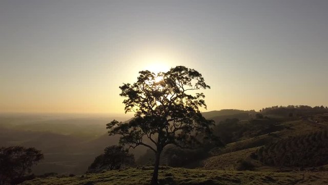 Footage aerial of sunrise in mountains and yellow sun