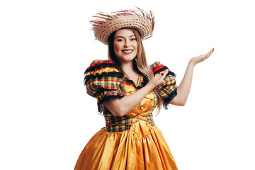 Fototapeta premium Brazilian woman wearing typical clothes for the Festa Junina showing something isolated on white background