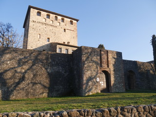 Fototapeta na wymiar Malaspina Castle in Bobbio. It was built by Malaspina family as a fortress with a massive tower and it was later converted into a residence by Dal Verme family. It dominates the panorama of the Trebbi