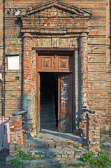 Old door in dilapidated house